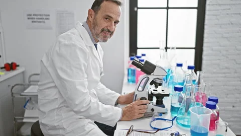 Smiling middle age man with grey hair, joyfully embracing science in his la.. Stock Footage 262203975