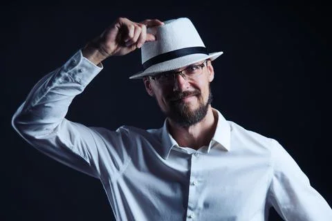 Smiling middle age man in hat lifting his hat Stock Photos