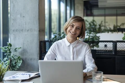 Smiling middle aged female operator call center  Stock Photos
