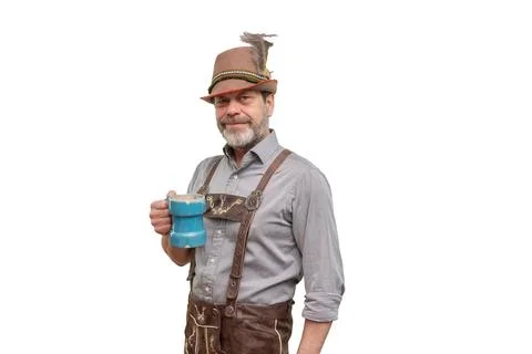 Smiling middle aged man in Bavarian costume holding blue tankard isolated 스톡 사진