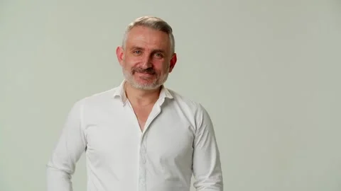 A smiling middle aged man is greeting family, friend or relative. A Video stock 252880181