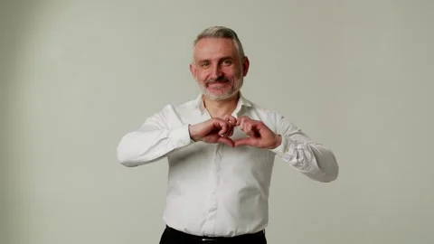 A smiling middle aged man is greeting family, friend or relative happily and Video stock 253035729