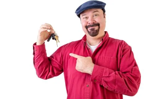 Smiling middle aged man pointing at car keys Stock Photos