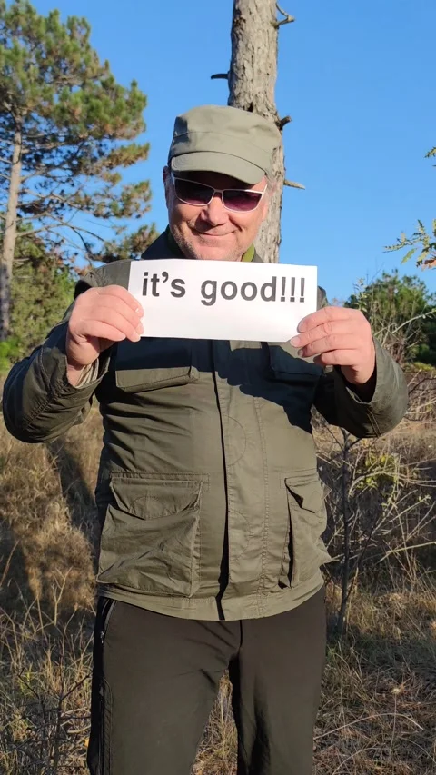 Smiling middle-aged man in sunglasses waves his hand invitingly Stock Footage 164550178