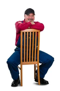 Smiling middle class worker sitting on chair Stock Photos