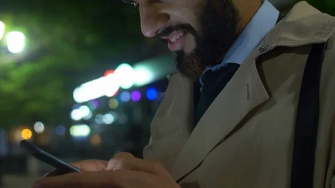 Smiling Middle Eastern man texting on smartphone Video stock 104415936