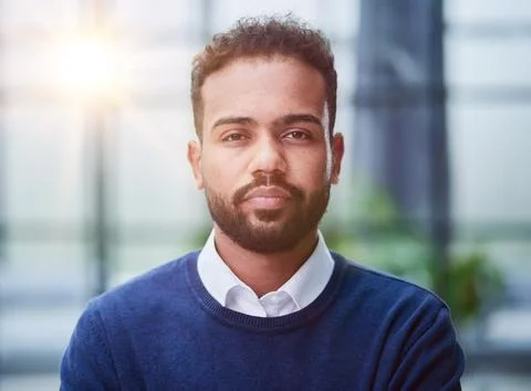 Smiling millennial confident black guy posing for photo, looking at camera Stock Photos