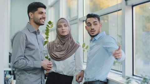 Smiling millennial multiracial employees talking gossips during break in office Stock Footage 165810034