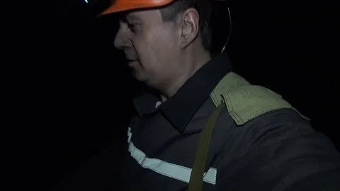 Smiling miner is in a coal mine Stock Footage 72664469