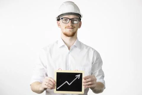Smiling mining engineer looks at camera holding sign with up arrow Stock Photos