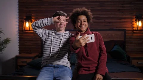 Smiling mixed race teens posing for selfie indoors Stock Footage 125410811