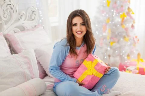 Smiling model with christmas present Stock Photos