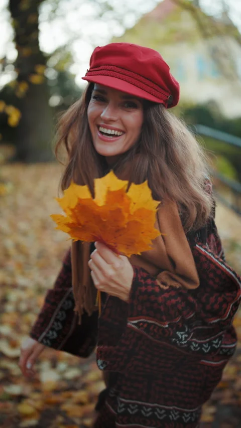 Smiling modern 40 years old woman in red hat walking Video stock 278669795