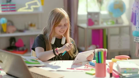 Smiling modern child learning online at home in sunny day Stock Footage 159368991
