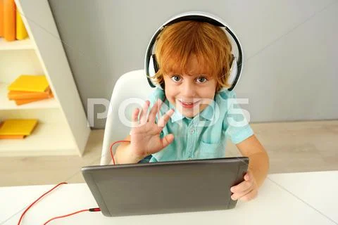 Smiling modern preschooler using portable computer Stock Photos