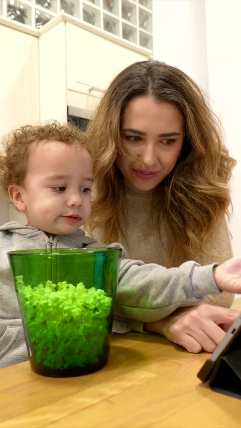 Smiling mother and cute son watching a tablet computer Stock Footage 329668302