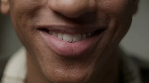 A CLOSE UP of a man smiling menacingly, , Stock Video