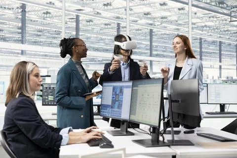 Smiling multiethnic engineering team using VR gear in microchip factory RD 스톡 사진