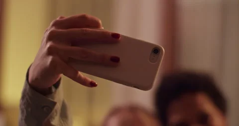 Smiling multiethnic girlfriends taking selfie at home Stock Footage 259715342