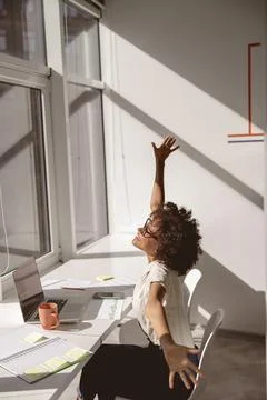 Smiling multiethnic lady having rest in the office Foto stock