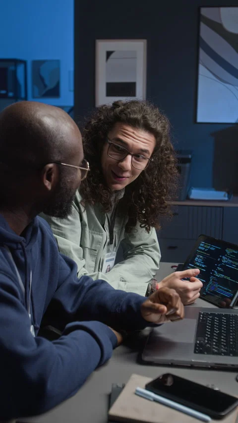 Smiling Multiethnic Teammates Discussing Work Tasks in Front of Laptop Screen Stock Footage 329614091
