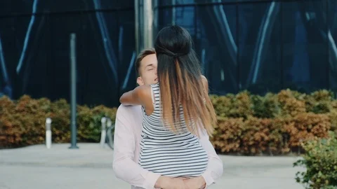 Smiling multiracial couple having fun spinning around on the street Stock Footage 119637987