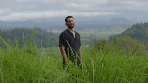 Smiling Multiracial Guy Standing in the Grass Field, Feeling Good. Retreat. Self Stock Footage 304459217