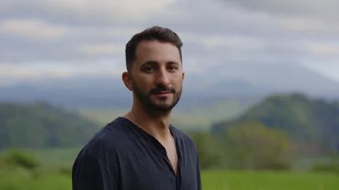 Smiling Multiracial Man Standing Outside in the Mountains, Posing to the Camera Video stock 258354413