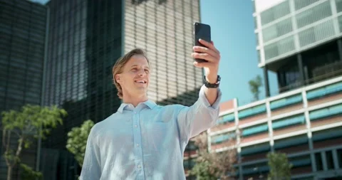 Smiling nice guy waving hand welcoming online video call with friends at modern Video stock 136675109
