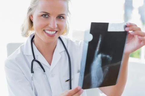 Smiling nurse analysing an x-ray Stock Photos