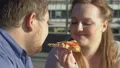 Smiling obese couple enjoying pizza taste, food passion, excess weight problem HD Footage