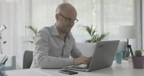 Smiling office worker chatting with his laptop Stock Footage 162303715