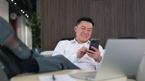 Smiling office worker using modern smartphone while resting after work Stock-Footage 251577169