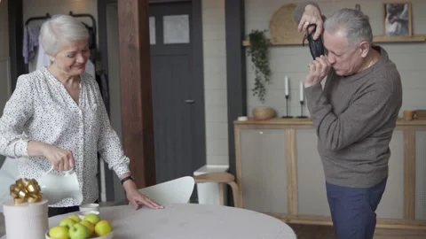 Smiling old lady posing for her husband for a photo Stock Footage 171939113