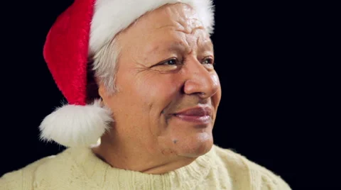 Smiling Old Man With Santa Cap Points At Xmas Gift Stock Footage 44311631