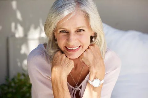 Smiling older woman with hand in hands outside Stock Photos