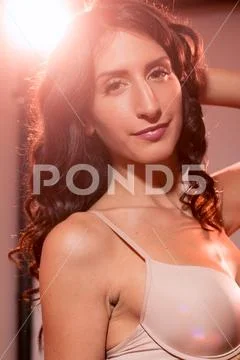 Smiling one young adult woman, upper body shot, wearing brassiere lingerie, b Stock Photos