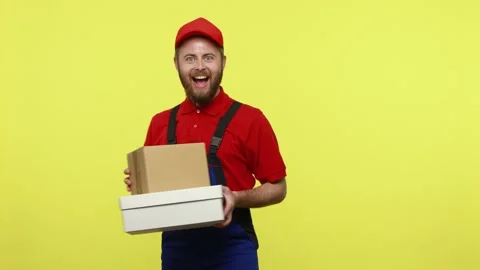 Smiling optimistic courier man going, holding cardboard parcels, giving order to Stock Footage 161437641