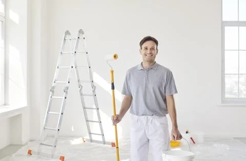Smiling Painter At Work During Home Renovation Stock Photos