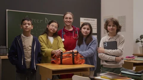 Smiling Paramedic Posing with Kids in School Stock Footage 328325586