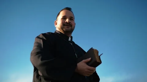 Smiling Parson Praying Under A Clear Sky Stock Footage 310681050