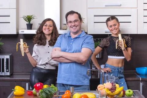 Smiling people  at kitchen Stock Photos