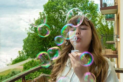 Smiling person playing with soap bubbles Stock-Fotos