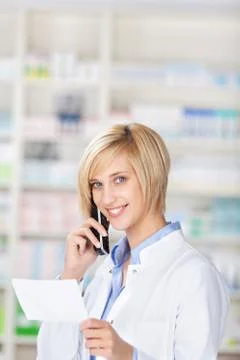 Smiling pharmacist using telephone Stock Photos