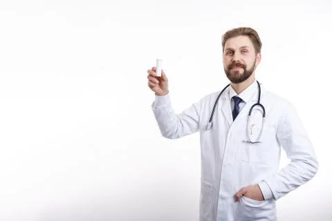 Smiling Physician With Stethoscope Demonstrating a Plastic Bottle of Medication Stock-Fotos