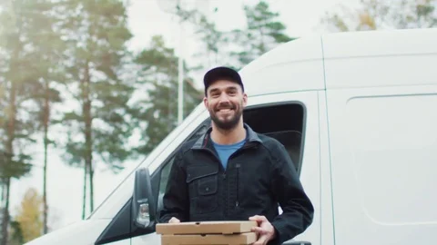Smiling Pizza Delivery Guy Delivers Two Pizzas. Sunny Autumn with Yellow Birches Stock Footage