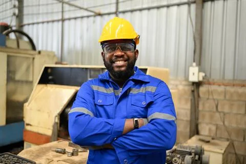 Smiling portrait of confident engineer worker at factory Stock Photos