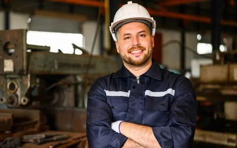 Smiling portrait of mechanical technician checking and inspecting machine Foto stock