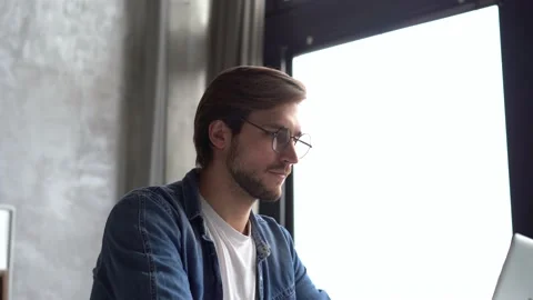 Smiling positive professional businessman working on laptop computer at home Stock Footage 142874853
