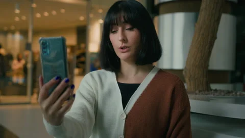 Smiling positive talking to smartphone webcam woman has video call indoors in Stock Footage 223697184